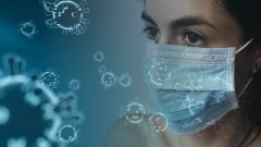 Corona-Pandemie - Person mit Maske und ein Virus